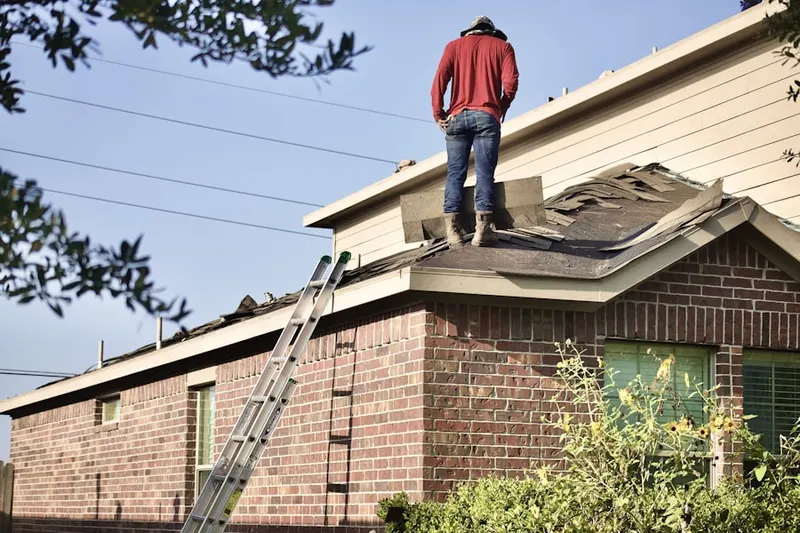 Professional roofer working on a residential roof in Etowah Shoals